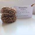 Ball of yarn with a label on a white surface