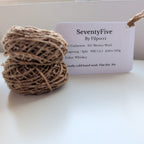 Ball of yarn with a label on a white surface