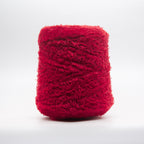 Cone of Tagliatino Merino Aran yarn in Melograno Rosso by Filati Venezia