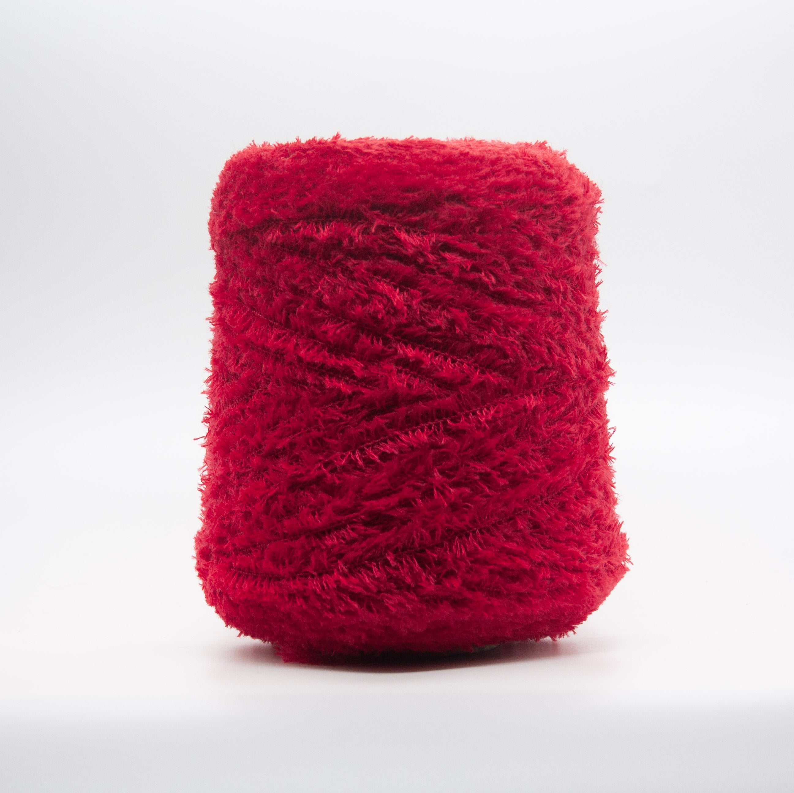 Cone of Tagliatino Merino Aran yarn in Melograno Rosso by Filati Venezia